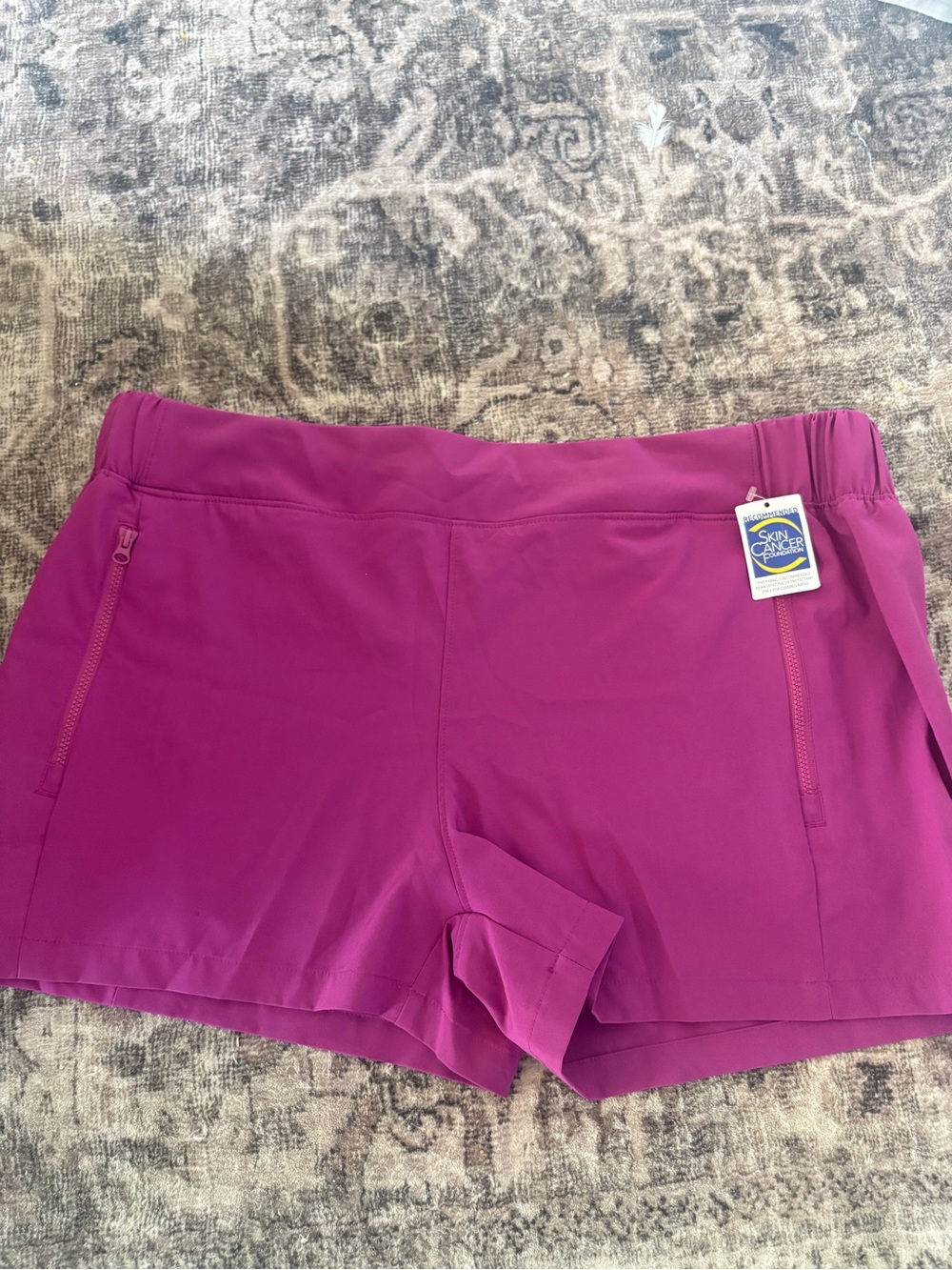 Reel Legends Women's Magenta Athletic Shorts with Zip Pockets.